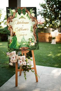 a welcome sign for a princess and the frog themed birthday party on a easel