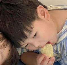 a boy and girl are eating food together