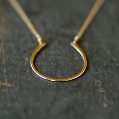 Hand-forged and hammered, this horseshoe of 14k gold filled has a nice size and a pretty finish for a lifetime of wear and love... and good luck! It is hung from a 14k goldfill chain and lends itself nicely to both dressing up and everyday wear. The horseshoe pendant measures approximately one inch long. Each horseshoe is handcrafted individually, so you can expect some slight variation from the piece pictured. Choose your necklace length from the drop-down menu. Gold Horseshoe Necklace For Formal Occasions, Formal Gold Horseshoe Necklace, Gold Horseshoe Jewelry For Anniversary, Gold Horseshoe Necklace For Good Luck, Classic Horseshoe Gold Necklace, Classic Horseshoe Jewelry As A Gift, Everyday Gold Horseshoe Necklace, Horseshoe Necklace Gold, Hexagon Engagement Ring