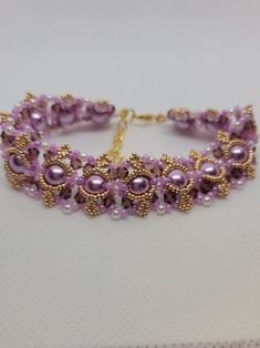 Beautiful and eye catching! This substantial bracelet warms quickly to your body temperature.  I'm going to call it lavender hue, and overall, that's the color you see, but so many colors come into play. Perfect for an evening out with friends or that special someone.  8mm lavender pearl beads 4mm dark purple czech bicone crystals 3mm white pearl beads 11/0 lavender seed beads 15/0 yellow gold seed beads Lobster clasp Extension chain Even though this bracelet is a bit longer, you need the extra Lavender Bracelets With Spacer Beads As Gift, Lavender Bracelets With Spacer Beads For Gift, Purple Beaded Bracelets For Wedding, Elegant Purple Crystal Bracelet With Spacer Beads, Elegant Beaded Lavender Bracelets, Elegant Lavender Beaded Bracelet, Elegant Purple Beaded Bracelet With Colorful Beads, Elegant Handmade Lavender Crystal Bracelet, Elegant Purple Beaded Crystal Bracelet