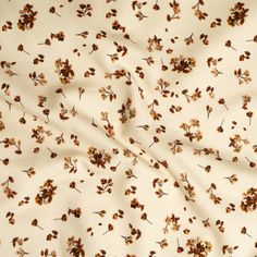 a white fabric with brown flowers on it