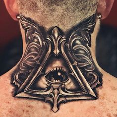 a man's neck with an all seeing eye tattoo on it