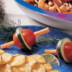 some food is laying out on a blue plate and next to a bowl of crackers