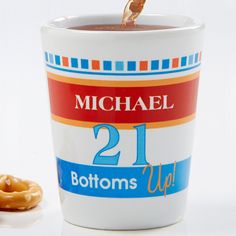 a cup of coffee with a donut on the side and michael 21 bottom down