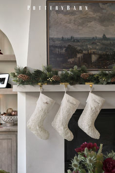 christmas stockings hanging from the mantel in front of a fireplace