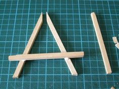 two pieces of wood sitting on top of a cutting board next to a pair of scissors