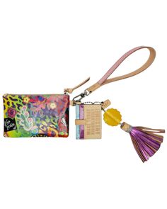 a small purse with a tassel and keychain attached to it, on a white background