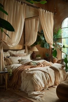 a large bed sitting in a bedroom next to a window with curtains on top of it