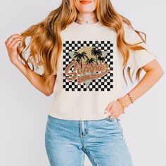 Looking for a cute versatile top to wear? Make sure to grab one of our Graphic tees! This soft and comfortable graphic tee is the perfect top for any outfit. It can be paired with biker shorts, jeans, or even a simple skirt/dress! This tee is true-to-size, so be sure to order your regular t-shirt size! If you are looking for a more oversized look, make sure to size up! Cute Cream Tops With Letter Print, Beige Graphic Tee With Letter Print, Cream Graphic Print Top For Summer, Cream Tops With Graphic Print And Relaxed Fit, Retro Cream Tops With Graphic Print, Retro Cream Top With Graphic Print, Cream Relaxed Fit Top With Graphic Print, Relaxed Fit Cream Top With Graphic Print, Cream Cotton Tops With Graphic Print