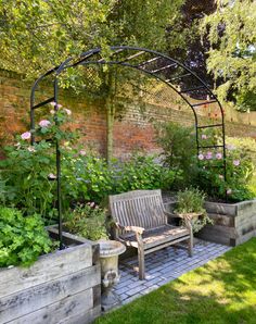 a wooden bench sitting in the middle of a garden