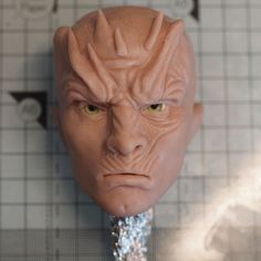 a close up of a plastic head on a table