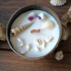 some shells and milk in a cup on a table