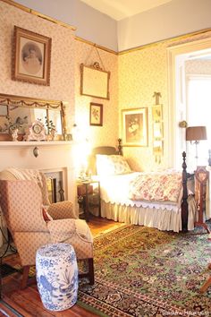 a bedroom with a bed, chair and fireplace