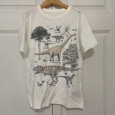 Never Worn Gap Kids Boys White Dinosaur Print Short Sleeve Shirt, Size M. In Excellent Condition And Always Been In A Nonsmoking Home! Tags Were Taken Off, But Never Worn Or Washed. Super Soft :) White Dinosaur, Gap Kids Boys, Dino Shirt, Dinosaur Shirt, Knit Denim, Gap Kids, Baby Gap, Dinosaur Print, Graphic Tee Shirts