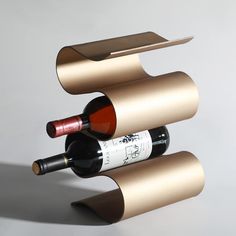 three wine bottles are stacked on top of each other