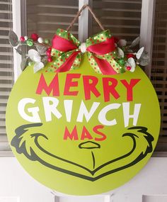 a merry grinch mas sign hanging on the front door