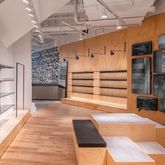 an empty room with lots of wooden shelves and glass cases on the wall behind them