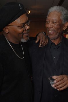 two men standing next to each other smiling