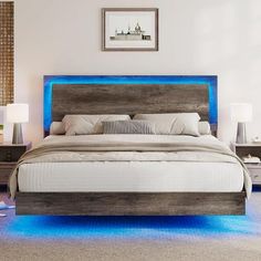 a large bed with blue lights on the headboard and foot board in a bedroom