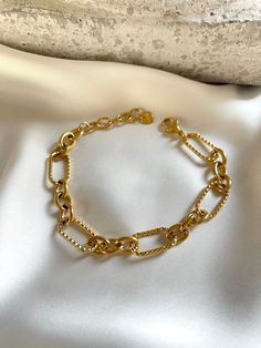 Stunning 18k gold plated bracelet. You can easily style it with every outfit day or evening, casual or occasional. Perfect piece to elevate your look! Made with most durable stainless steel material. So you could enjoy our creations for longest time. M E A S U R E M E N T S Length = 15cm + adjustable extension Chain 5cm; Width = 11mm C A R E T I P S ✔️ Please remove jewelry before showering, swimming and sleeping. ✔️Avoid direct use of perfumes, lotions or other harsh chemicals on the item. ✔️Store in a cool dry place, ideally in a separate compartments to prevent scratching. ✔️Gently wipe jewelry with a polishing cloth to clean and maintain shine. Why jewelry is made from from Stainless steel? Stainless steel ranks 6th on the Mineral Hardness rank, while others such silver ranks at 2.5. T Gold Plated Bracelets, Unique Gifts For Her, Beautiful Gift Boxes, Adjustable Bracelet, Chain Link Bracelet, Things To Buy, Chain Bracelet, Beautiful Necklaces, Lotion