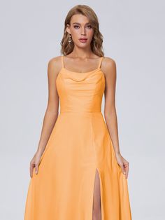 a woman is wearing an orange dress with a slit in the side and one leg