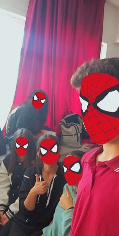 a group of people wearing spider man masks