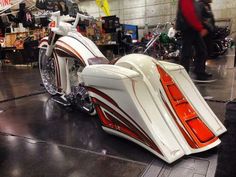 a white and red motorcycle parked inside of a garage