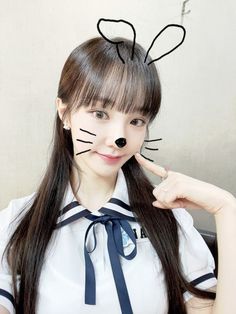 a girl with long hair and cat ears on her head is posing for the camera