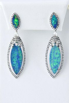 For Sale on 1stdibs - Stunning Well Matched Opal Doublet Earrings mounted in 18 karat white gold accented with 1.82 carats of diamonds. Luxury Multi-stone Diamond Earrings For Formal Occasions, Luxury Multi-stone Diamond Earrings, Elegant Multi-stone Diamond Earrings, Formal Multi-stone Diamond Earrings, Elegant Multi-stone Diamond Earrings For Formal Occasions, Multi-stone White Gold Earrings For Formal Occasions, Formal Teardrop Multi-stone Earrings, Luxury Pear-shaped Earrings With Pave Setting, Formal Multi-stone Teardrop Earrings