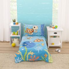 a child's bedroom with blue walls and underwater themed bedding