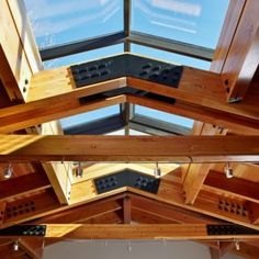 the inside of a wooden building with skylights