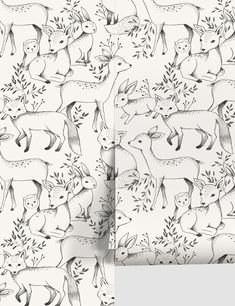 two different wallpapers with deer and plants in black and white on the same wall