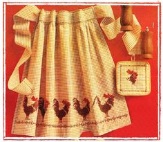 an image of a kitchen set with roosters on the apron and potholders in it