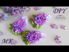 purple flowers are arranged on a table with the letters dk and k above them