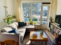 a living room filled with furniture and a flat screen tv sitting on top of a wooden table