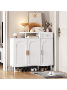 a white cabinet sitting on top of a hard wood floor