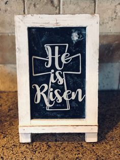 a black and white sign that says he is risen