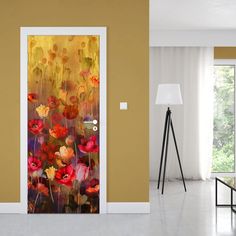 an open door with flowers painted on it in front of a living room wall and floor lamp