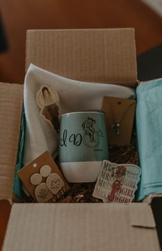 an open box that has some items in it and is on top of a table