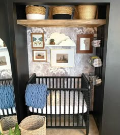 a baby crib in a room with pictures on the wall and other items around it