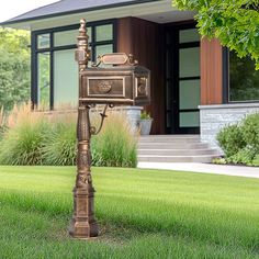 a mailbox in the grass near a house