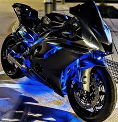 a black and blue motorcycle parked on the street