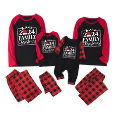 the family pajamas are red and black with plaid print on them, while the baby is wearing