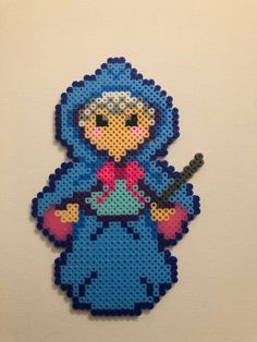 an image of a cartoon character made out of perler bead beads on a white wall