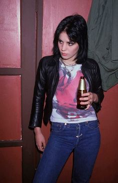 a woman holding a beer in her right hand