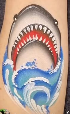 a tattoo with a shark's teeth on it