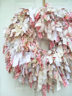 a wreath made out of old clothes hanging on a door