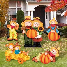 inflatable pumpkins and scarecrows are sitting on the lawn with their babies