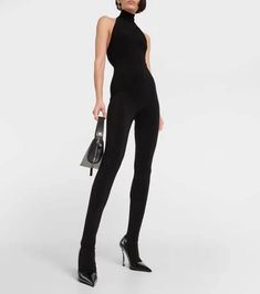 An easy elegance underpins Norma Kamali's catsuit. Made for a close fit, this halterneck style has an open back and stirrup feet..Made in China.Material: 5% elastane, 95% polyester.Care instructions: machine wash cold.Designer color name: Black.True to size.Low back.Fitted.Mid-weight material.Stretchy fabric.Skinny leg.The model seen in the picture is 178cm-5'10' and wearing a size XS Elegant Fitted High Neck Jumpsuit, Stretch Halter Neck Bodysuit For Evening, High Stretch Elastane Bodysuit For Evening, Sleek Sleeveless Fitted Unitard, Sleek Fitted Sleeveless Unitard, High-stretch Elastane Unitard For Party, High Stretch Elastane Unitard For Party, Elegant Stretch Unitard, Elegant Fitted Halter Neck Bodysuit