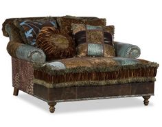 a brown and blue couch with pillows on it